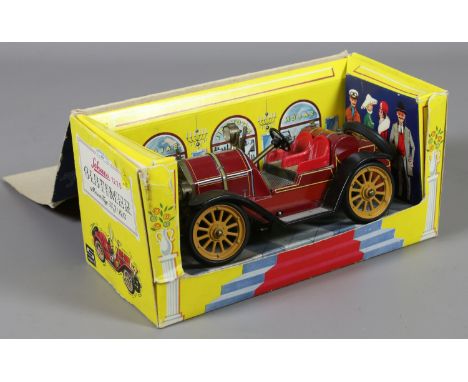 A boxed Schuco old timer tin plate clock work toy/medal car.