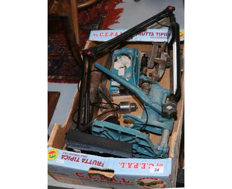 A box of tools, along with a modern desk lamp and shade.