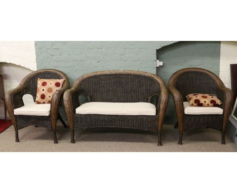 A contemporary rattan conservatory suite comprising; two seater sofa and two arm chairs.