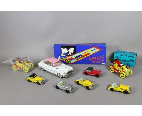 A collection of vintage tin plate toy/model cars including boxed examples.
