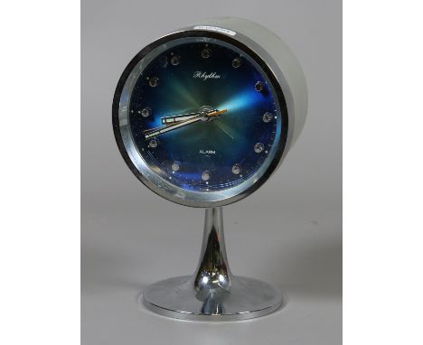 A 1950s style silvered pedestal alarm clock with blue satin dial signed Rhytham.