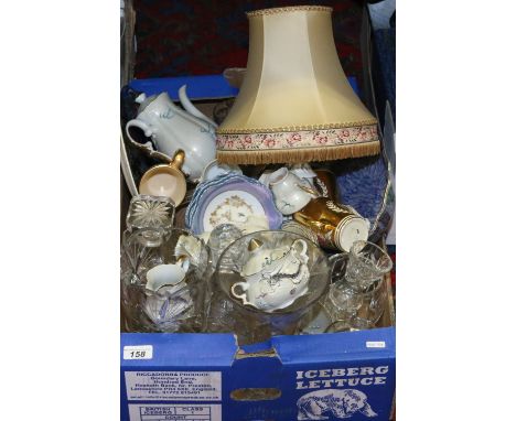 A box and contents of mixed china and glass to include decanters and flatwares, along with a Limoges table lamp and shade.