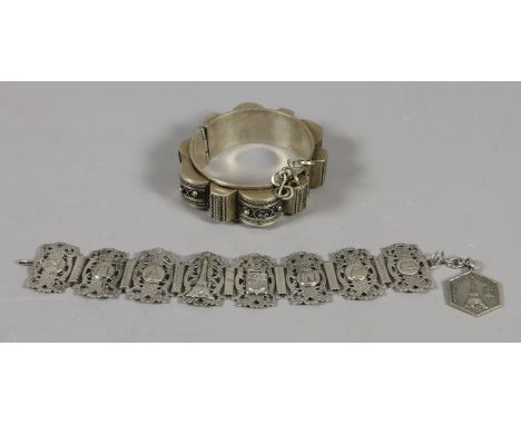 A silver filigree work bangle and a similar pierced bracelet. 