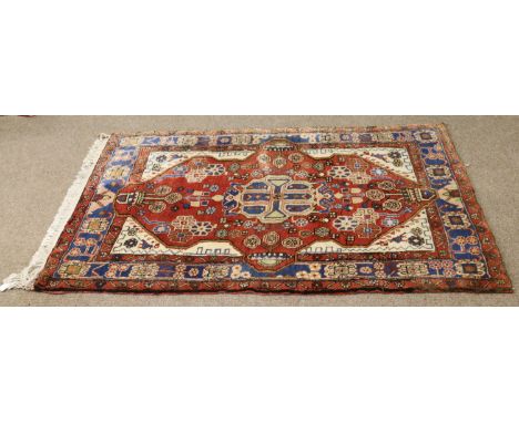 A red ground hand made Iranian wool carpet, 60 x 40 inch.
