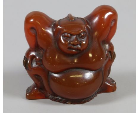A Japanese carved amber netsuke.
