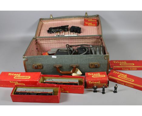 A vintage suitcase containing Triang oo gauge model railway including boxed Diesel loco T.C series, rolling stock and unboxed