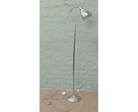 A modern chrome adjustable standard lamp and shade.