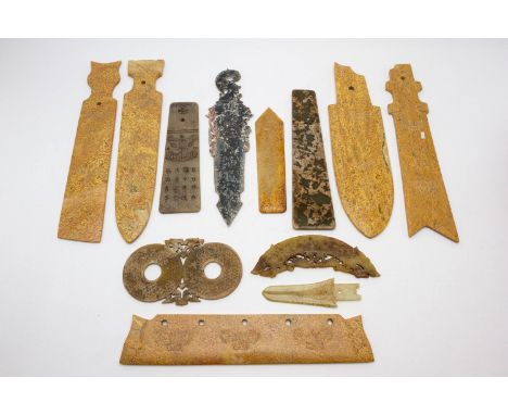 A GROUP OF TWELVE ARCHAIC STYLE STONE CARVINGS
Including ceremonial axe head style carvings; a dagger etc
The largest48cm lon