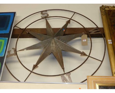 A metal weather vane sign having a starburst outline with the four points of the compass, dia. 106cm