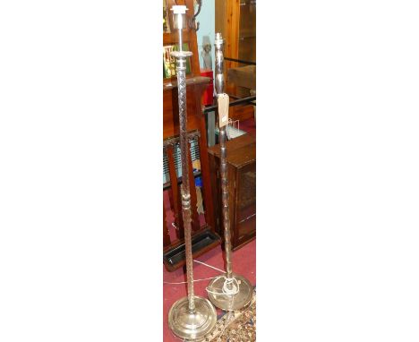 A contemporary silvered metal bobbin turned standard lamp; together with another similar glass spiral turned column example (