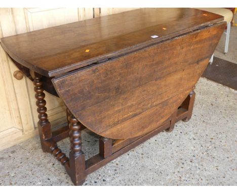 An 18th century oak bobbin turned gateleg dining table, w.123cm 