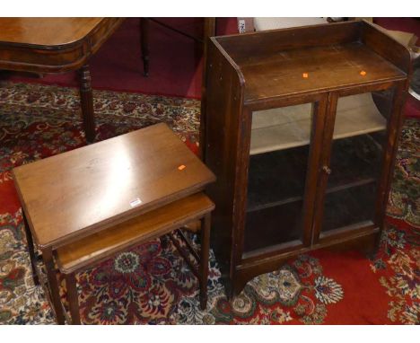 A 1930s small oak double door glazed low bookcase; together with a mahogany nest of two occasional tables; and a turned stand