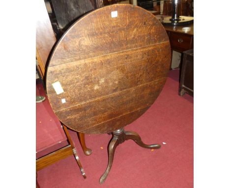 An early 19th century provincial oak circular tilt-top pedestal tripod table, dia. 81.5cm