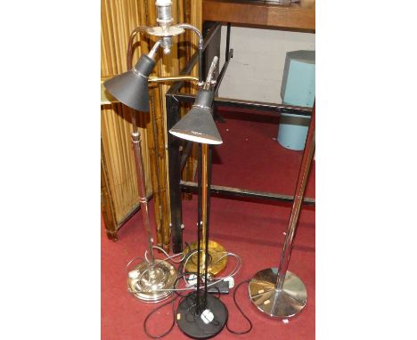 A contemporary polished chromed metal up-lighter; together with a brass adjustable standard lamp; a silvered metal standard l