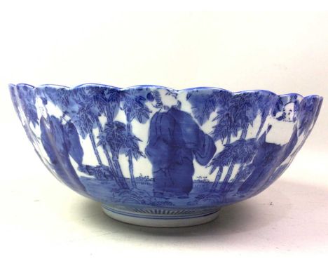JAPANESE BLUE AND WHITE BOWL, 20TH CENTURY of scalloped form, decorated with a continuous scene of figures31.5cm high 