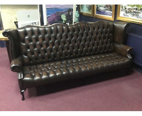 LARGE BUTTON BACK SETTEE, in dark tan leather, on mahogany cabriole legs105cm high, 248cm wide 150cm high, 238cm wide, 80cm d