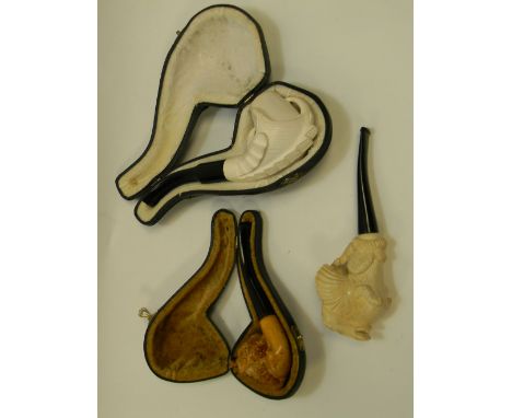 A collection of  Meerschaum Pipes including: Peterson Dragon,  cased fisherman's head and modern similar item 