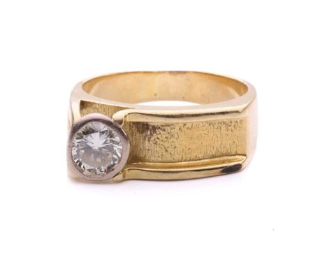 A Modernist diamond-set dress ring, composed of a ridged textural channel, featuring an irregular-shaped faceted diamond in a