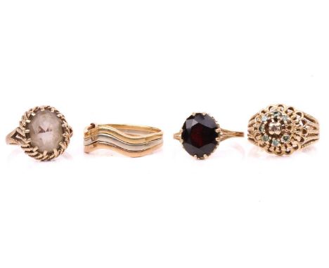 Three gem-set rings and a trinity ring; including a red paste solitaire ring in 9ct gold, size S; a quartz dress ring with a 