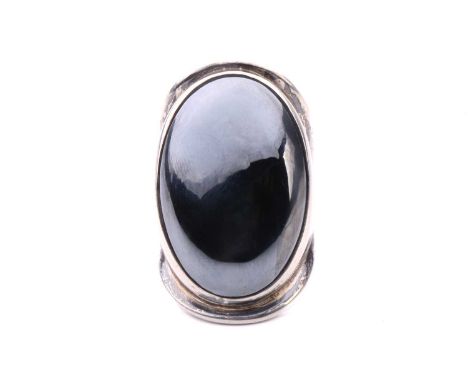 Bent Knudsen - a large hematite cocktail ring, comprising an oval hematite cabochon in a collet setting, approximately measur