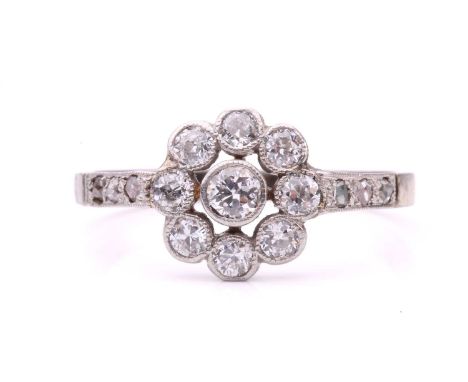 A diamond floral cluster ring, set with a central cluster of round old cut diamonds with a total estimated weight of 0.50ct, 