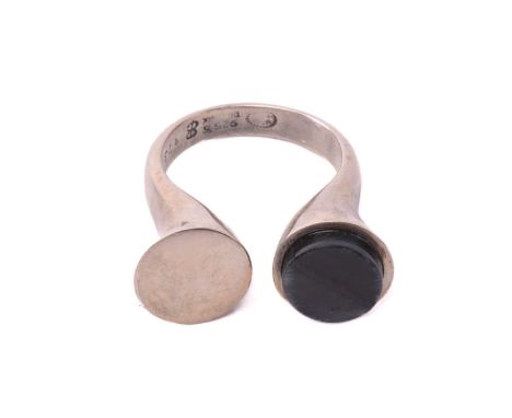 Georg Jensen - a dress ring with polished hawk's eye, comprises an open shank with a flat round panel end, the other a round 