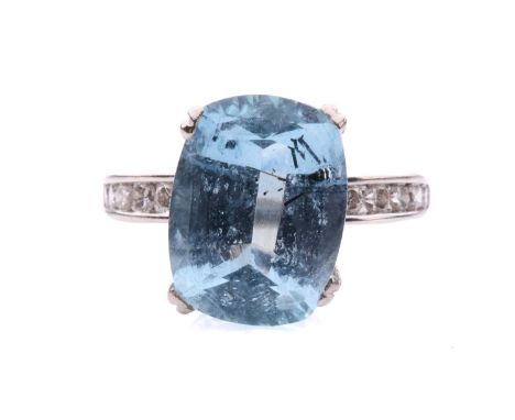 An aquamarine solitaire ring, featuring a cushion-cut aquamarine of light blue colour with schorl inclusions, approximately m