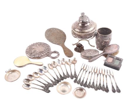 A collection of silver items including a sugar bowl with stand, the cover with a hawk finial, three hand mirrors; one in silv