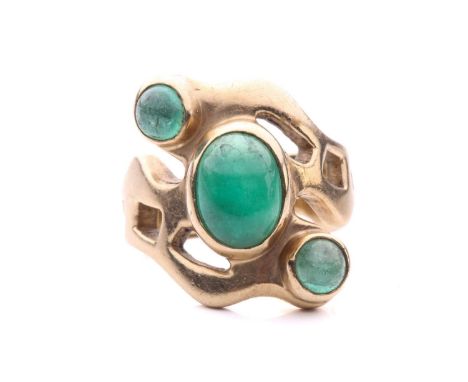 An emerald three stone ring, set with three cabochon emeralds to a large gold ring of organic form, in 9ct gold with full UK 