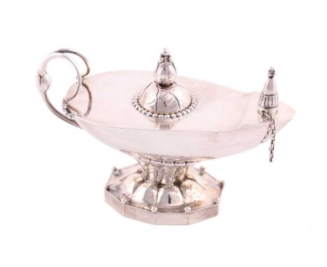 A Georg Jensen oil lamp, design no.12, the lamp with blossom finial, scroll and beaded handle, leaf decorated stem with ribbe