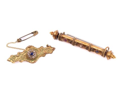 Two Victorian brooches, the first a bar brooch in the Etruscan revival style, set with a sapphire, a diamond and a ruby, meas