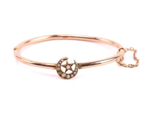 A Victorian hinged bracelet of celestial design, constructed of two hollow arched tubular bands, featuring a crescent and sta