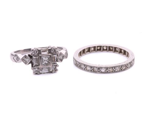 A diamond cluster ring in 18ct gold and a diamond eternity ring; the square cluster ring composed of a princess-cut, four bag