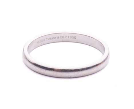 Tiffany &amp; Co. - a wedding band in platinum, composed of a plain court-profile band, signed Tiffany &amp; Co. 1999, London