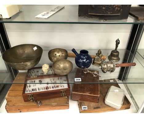 A Buddhist prayer wheel, three singing bowls, a temple bell, etc. 