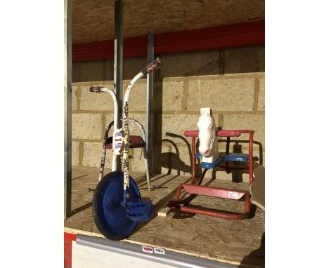 A Vintage Tri-Ang rocking horse and a tricycle.