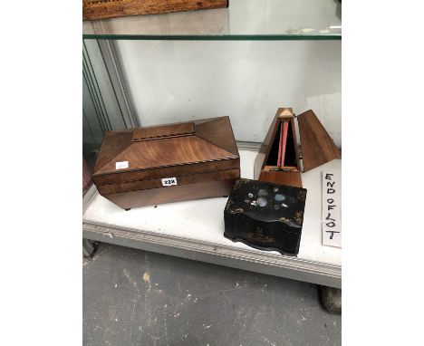 Two 19th-century tea caddies and a metronome. 