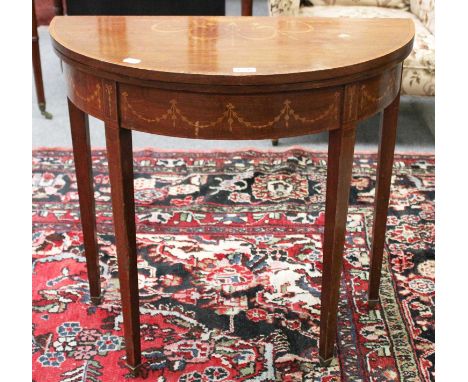 An Edwardian Mahogany Demi Lune Card Table, inlaid and crossbanded, 75cm by 38cm by 72cmAn area of damage to the top, approxi