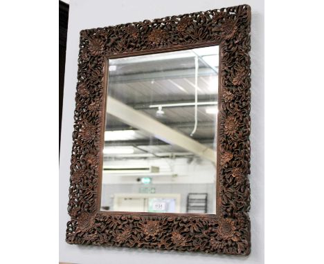 A Chinese Mirror, with an ornately carved frame, 61cm by 70cmSeveral losses to the outer most carving, otherwise ok