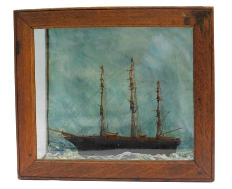 A 19thC model of a tea clipper, on painted waves, contained in an oak and glass case, 32cm x 36.5cm. 