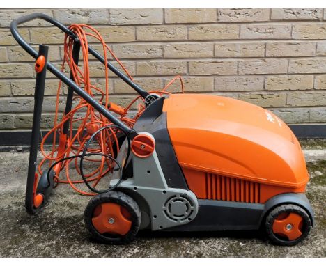 A Flymo Lawn Rake compact 3400 electric mower. 