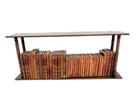 A 20thC oak hanging bookcase, containing various works of fiction, to include Stephenson (RL) Essays of Travel, Harte (Bret) 