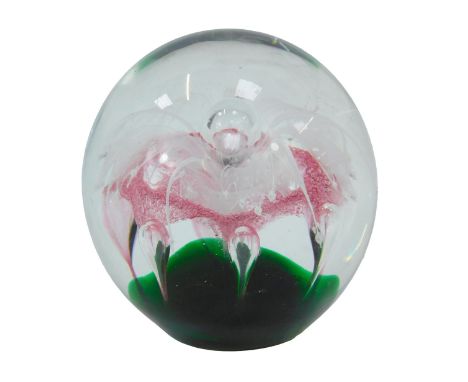 A glass paperweight, of orb form, decorated centrally with a pink and white flower, 11cm high. 