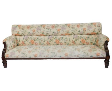 A Georgian style mahogany framed three seater sofa, with overstuffed floral fabric, raised on turned legs, 234cm wide. 