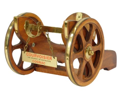 A Courvoisier Cognac bottle stand, modelled as a cannon carriage, 14cm high, 17cm wide.