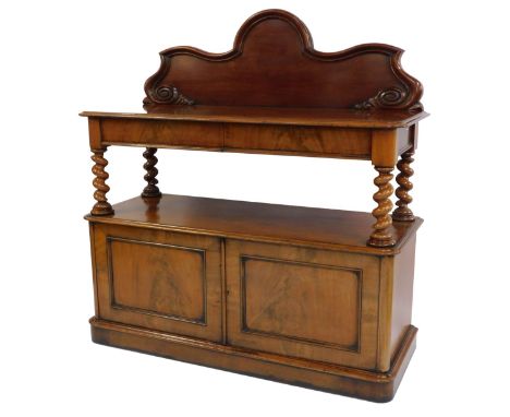 A Victorian mahogany buffet, with a shaped and carved back, over two cushion drawers, raised on barley twist supports, above 