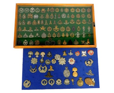 Two military cap badge displays, comprising shoulder cuffs, deer and stag, Connaught Ranges, First Hand Volunteers and others
