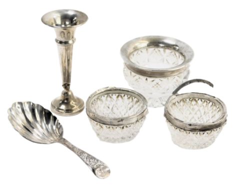 Three silver rimmed and cut glass salts, a miniature silver trumpet vase, 0.54oz gross, and a silver plated fluted caddy spoo