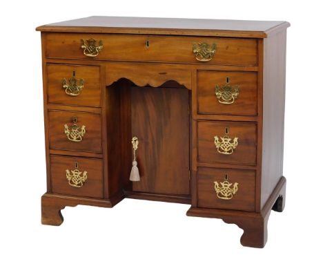 A 19thC style mahogany kneehole desk, the top with a moulded edge above one long and six short drawers, with cupboard to base