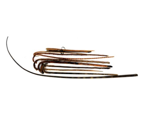 A group of wooden walking sticks, of varying designs, together with a leather coaching whip, etc. (a quantity)